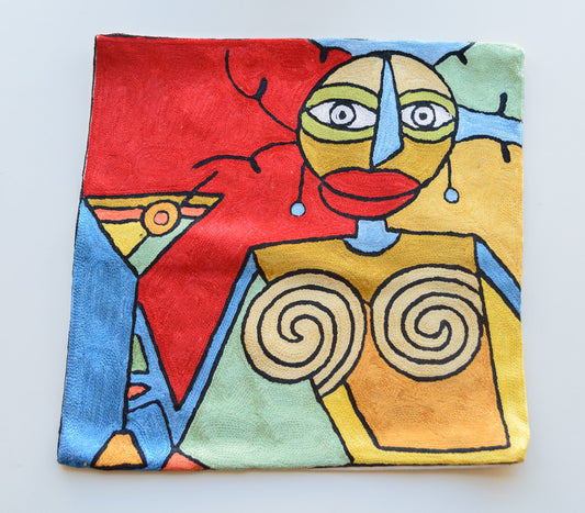 A close up cushion cover with very vivid colors. It depicts a woman holding a margarita glass inpired art from famous painters, Alfred Gockel and Picasso. The colors of the background are red, dark blue and light blue, yellow and light green. The colors of the lady are red for her lips, white eyes, blue nose, yellow head, yellow body.